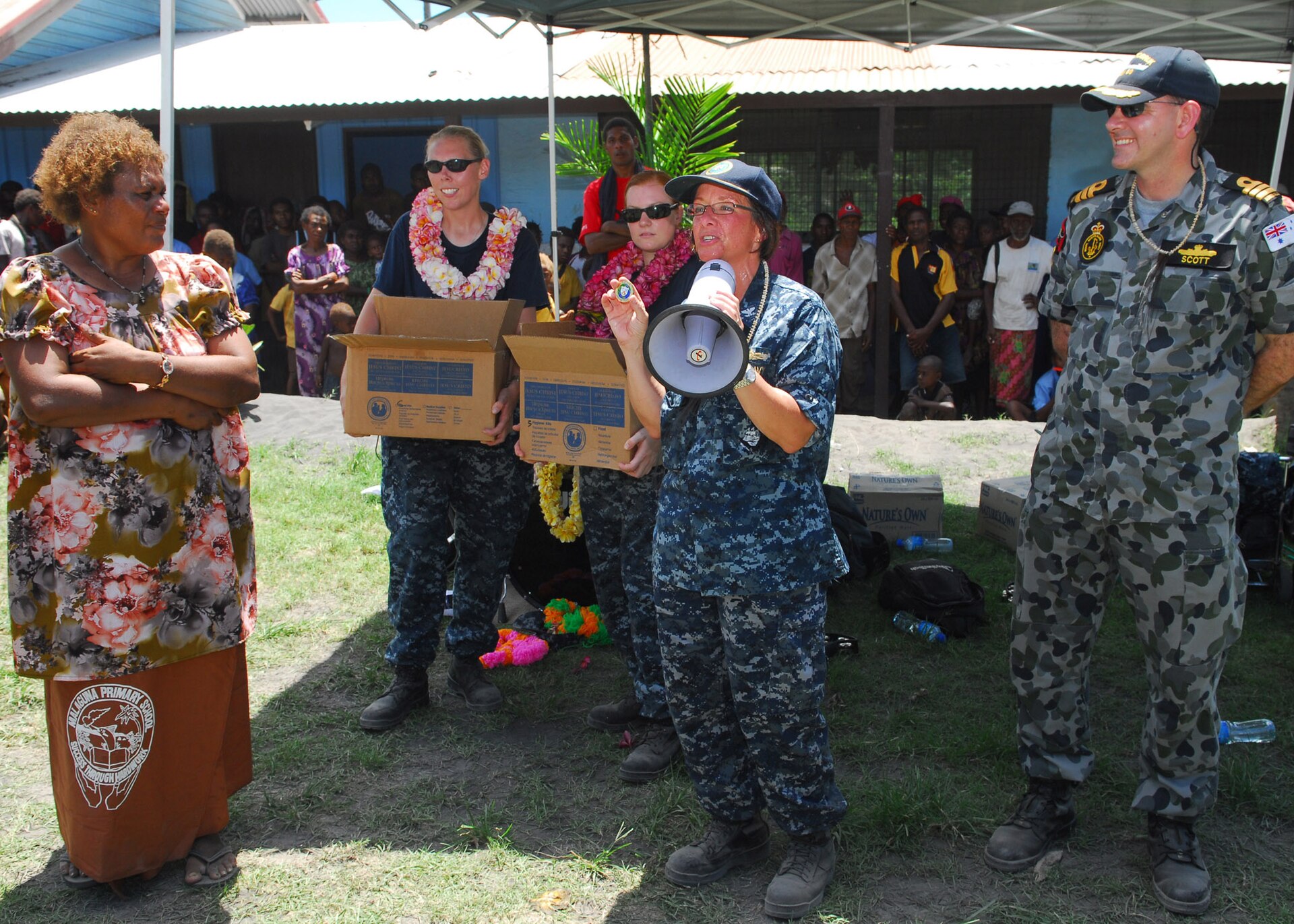 RABAUL, Papua New Guinea (Sept. 7, 2010) Capt. Lisa M. Franchetti, commander of Pacific Partnership 2010, embarked aboard the Royal Australian Navy landing ship heavy HMAS Tobruk (L50), presents a command coin to Jacobeth Bakut, head teacher of Malaguna Primary School, during a community service event. A contingent of 64 Sailors and non-governmental organization members assigned to the Military Sealift Command hospital ship USNS Mercy (T-AH 19) are embarked aboard Tobruk conducting the final leg of Pacific Partnership 2010. Pacific Partnership is the fifth in a series of annual U.S. Pacific Fleet humanitarian and civic assistance endeavors aimed to strengthen regional partnerships. (U.S. Navy photo by Mass Communication Specialist 2nd Class Eddie Harrison/Released)